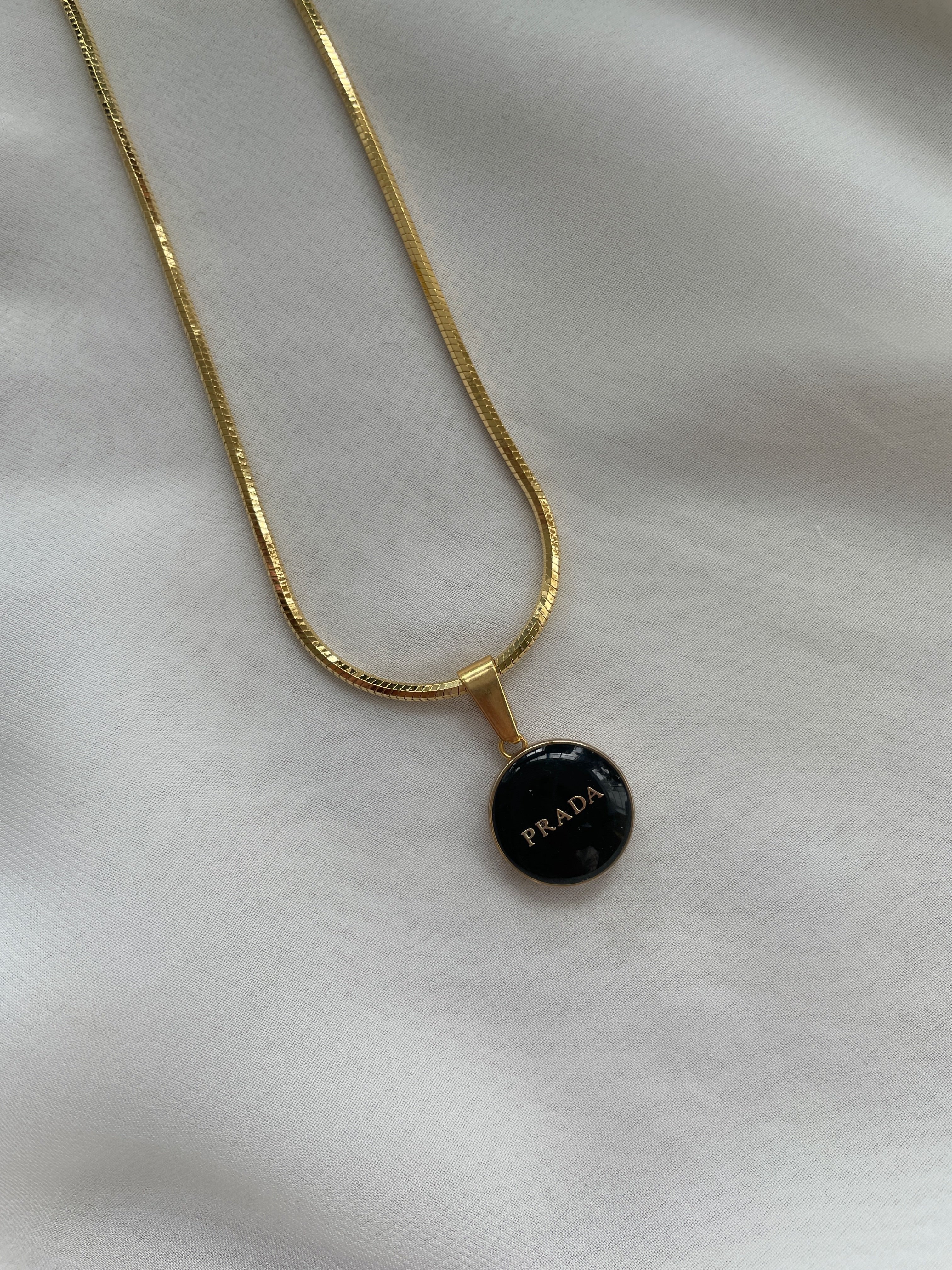 Prada Badge Bolo Necklaces - Black, White, Pink - Designer Button